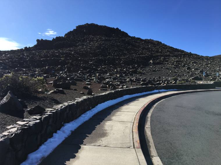 COURTESY NATIONAL PARK SERVICE/JAMIE MANSFIELD
                                Snow was seen along the sidewalk at Halekala’s summit, Wednesday, on Maui.
