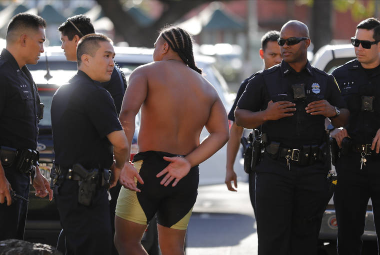 JAMM AQUINO / JAQUINO@STARADVERTISER.COM
                                Leilehua wrestler Vitale Afoa is arrested by police after a quarrel with HHSAA support and security staff during the quarterfinal round of the 2020 HHSAA Wrestling Championship today at Blaisdell Arena.