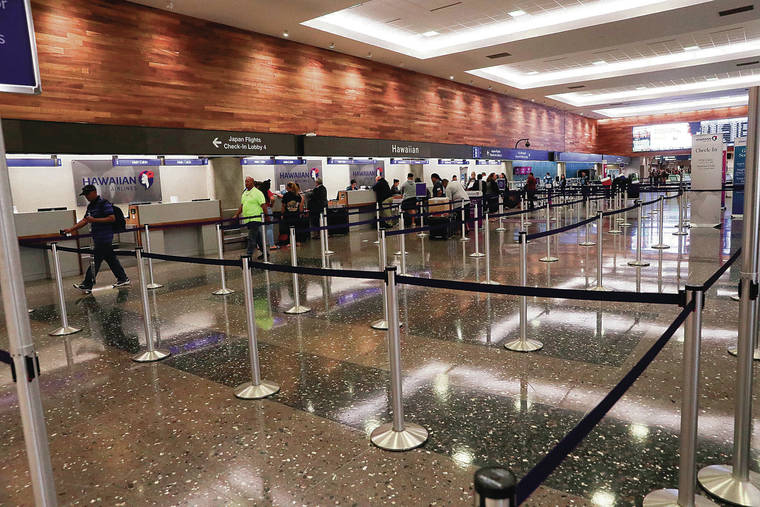 JAMM AQUINO / JAQUINO@STARADVERTISER.COM
                                The check-in lobby of Hawaiian Airlines was nearly empty Monday at Daniel K. Inouye International Airport.