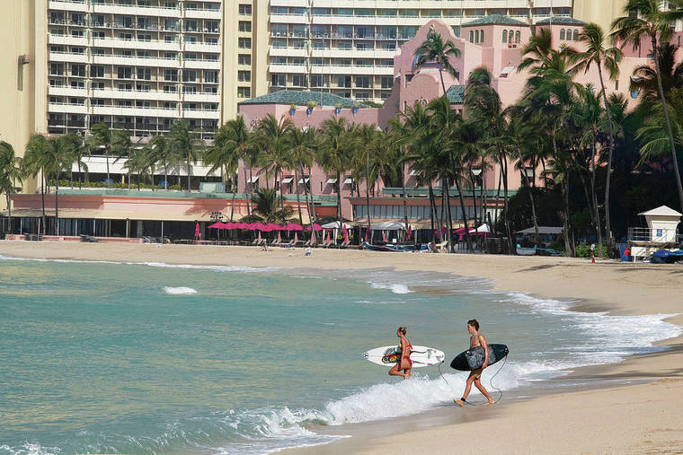 CRAIG T. KOJIMA / CKOJIMA@STARADVERTISER.COM
                                Surfers took advantage of an empty beach in Waikiki on Tuesday.