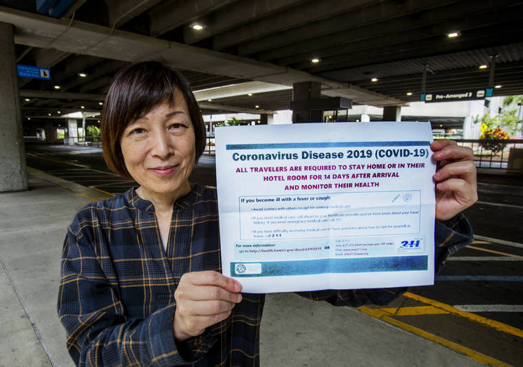 DENNIS ODA / DODA@STARADVERTISER.COM
                                Miwako Yamamoto, who was returning from Japan to Honolulu, where she is a massage therapist, displayed a form handed out Thursday by Hawaiian Airlines.