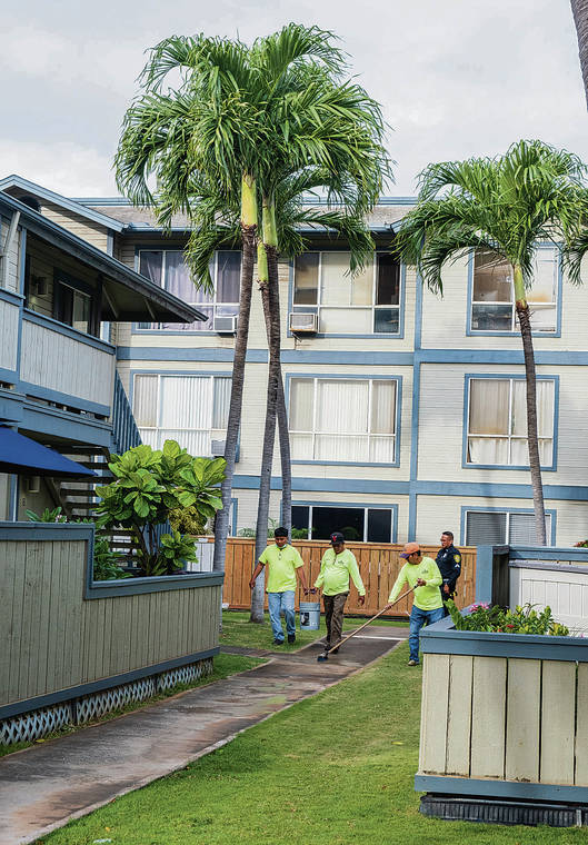 DENNIS ODA / DODA@STARADVERTISER.COM
                                Workers on Thursday cleaned the area near the unit where a woman, 23, and her 6-month-old baby were killed Wednesday.