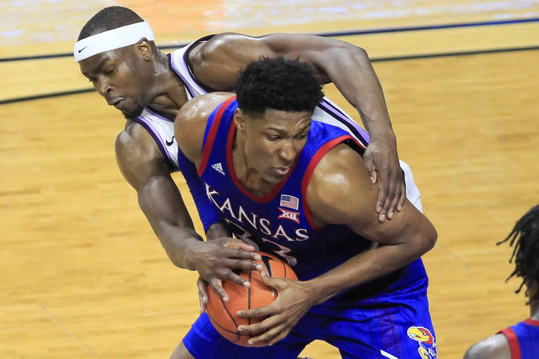 ASSOCIATED PRESS
                                Kansas forward David McCormack (33) is fouled by Kansas State forward Makol Mawien, left, during the second half of an NCAA college basketball game in Manhattan, Kan., on Saturday. Kansas defeated Kansas State 62-58.