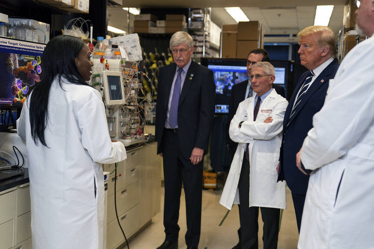  Dr. Kizzmekia Corbett, left, senior research fellow and scientific lead for coronavirus vaccines and immunopathogenesis team in the Viral Pathogenesis Laboratory, talked with President Donald Trump, March 3, as he toured the Viral Pathogenesis Laboratory at the National Institutes of Health in Bethesda, Md. Dozens of research groups around the world are racing to create a vaccine as COVID-19 cases continue to grow.