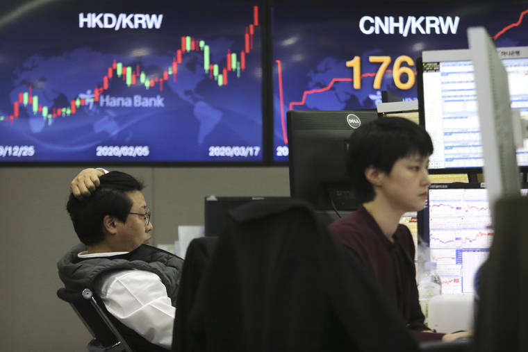 ASSOCIATED PRESS
                                Currency traders watch monitors at the foreign exchange dealing room of the KEB Hana Bank headquarters in Seoul, South Korea, on Tuesday.