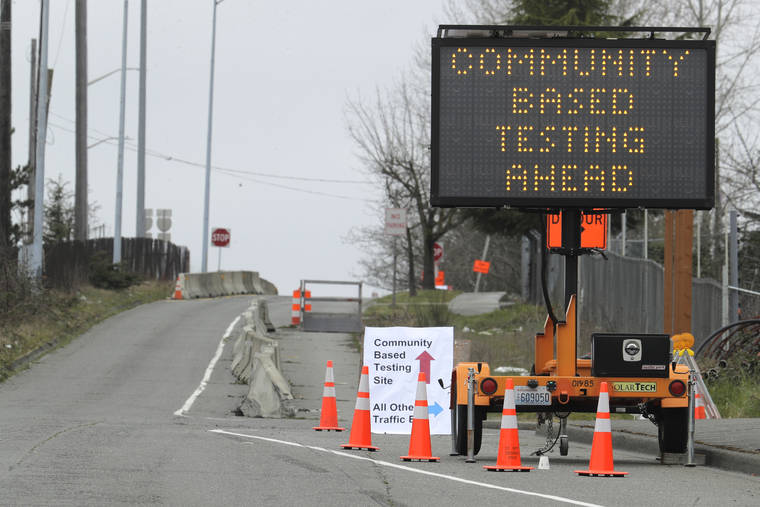 ASSOCIATED PRESS
                                A sign directs vehicles toward a drive-up testing site at the Tacoma Dome in Tacoma, Wash.