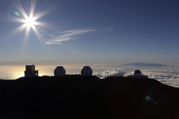 ASSOCIATED PRESS / 2019
                                The sun sets behind telescopes at the summit of Mauna Kea. The observatories have shut down their operations in response to Gov. David Ige’s stay-at-home order aimed at preventing the spread of COVID-19.