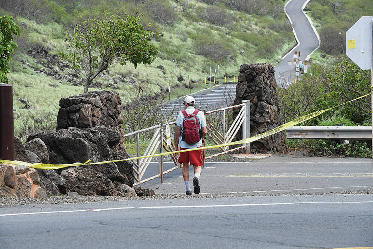 BRUCE ASATO / BASATO@STARADVERTISER.COM
                                A hiker Tuesday stepped over the yellow police tape near the locked gate that leads to the Makapu‘u Point Lighthouse Trail.