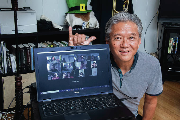 CRAIG T. KOJIMA / CKOJIMA@STARADVERTISER.COM 
                                Greg Kim, a corporate lawyer, is organizing a growing group of volunteers to make free deliveries to kupuna and others in need. Kim poses with his volunteers during a teleconferencing session.