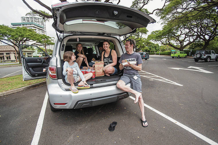 CINDY ELLEN RUSSELL / CRUSSELL@STARADVERTISER.COM
                                Siblings Islay, left, Aurora and Ridgedon dined Wednesday in the luggage area of their car with their parents Amanda and Jason Johnson, while on vacation in Hawaii. Also seated in the car but not visible was their son Dyson.