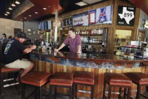 KAT WADE / SPECIAL TO THE STAR-ADVERTISER
                                Hawaii Kai resident Riley O’Riley, left, chats with bar manager Brady Collier. Tex 808 opened last summer and occupies the former BYO Bowls location at the Hawaii Kai Shopping Center.