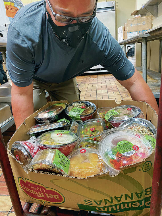 COURTESY CHEF HUI
                                Chef Kealoha Domingo helps unload a delivery of donated packaged meals from ABC Stores.