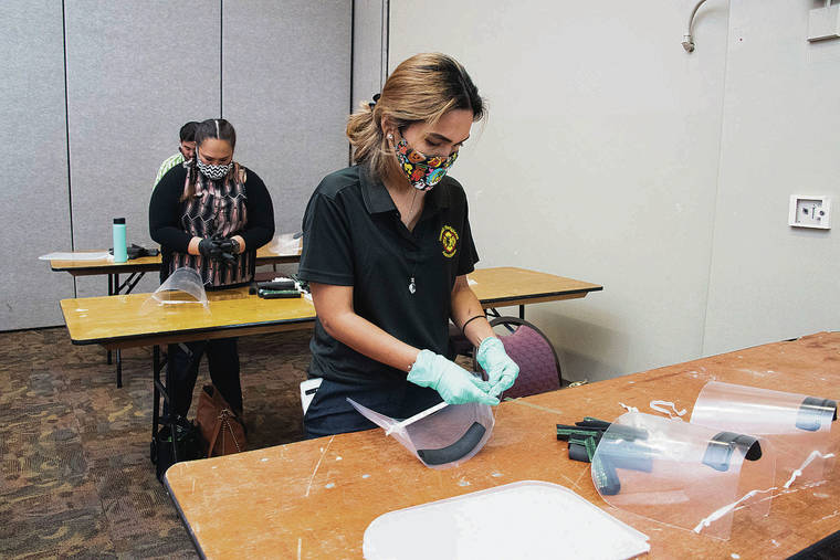 CRAIG T. KOJIMA / CKOJIMA@ STARADVERTISER.COM
                                Jolyn Garidan-Prieto of the Hawaii Firefighters Association joined other volunteers Thursday at the Neal Blaisdell Center, where they assembled face shields for medical staff and other essential workers.