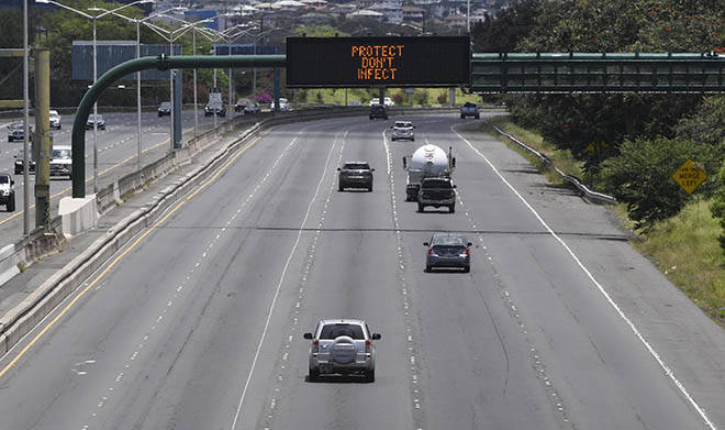 BRUCE ASATO / BASATO@STARADVERTISER.COM
                                There were few cars on H-1 freeway near Joint Base Pearl Harbor-Hickam Sunday and a state message board that alternately tells the public to “Protect don’t infect” and to “Stay home.” Hawaii’s tally of coronavirus cases rose today to 609, up two from Monday with both cases from Maui County.