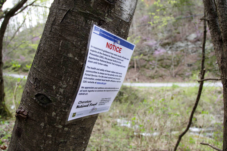 ASSOCIATED PRESS
                                A notice is nailed to a tree along a portion of the Appalachian Trail in Cosby, Tenn., on March 30. Hikers have been asked to leave the trail immediately as trailheads continue to close due to the coronavirus outbreak.