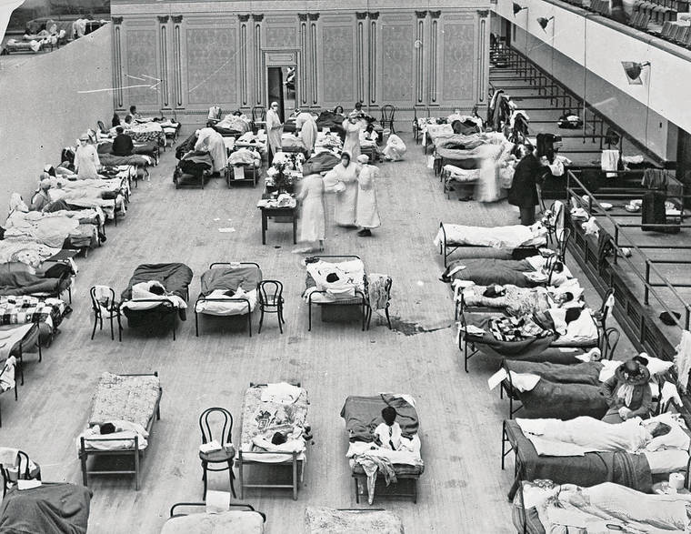 EDWARD A. “DOC” ROGERS / LIBRARY OF CONGRESS VIA ASSOCIATED PRESS
                                In the above 1918 photo, volunteer nurses from the American Red Cross tended to influenza patients in the Oakland, Calif., Municipal Auditorium, which was used as a temporary hospital.