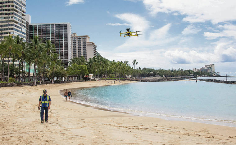 CRAIG T. KOJIMA / CKOJIMA@STARADVERTISER.COM
                                The Honolulu Fire Department demonstrated Friday how talking drones will be used to reinforce the mayor’s stay-at-home/work-from-home order at beaches around Oahu.