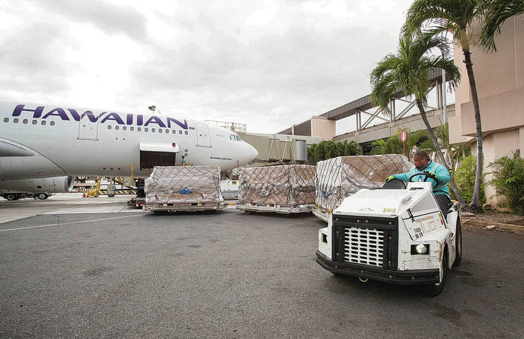 CINDY ELLEN RUSSELL / CRUSSELL@STARADVERTISER.COM A
                                Hawaiian Airlines fl ight chartered by Every1ne Hawaii arrived Tuesday at Daniel K. Inouye International Airport with 1.6 million face masks from China.