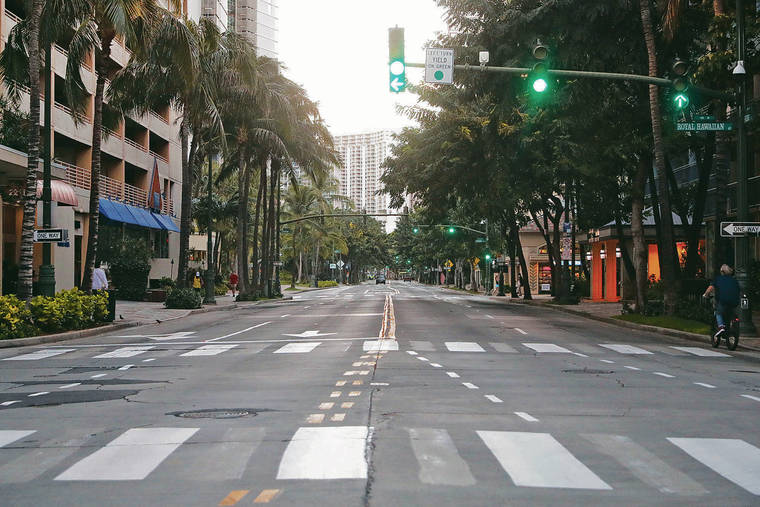 JAMM AQUINO / JAQUINO@STARADVERTISER.COM 
                                Usually a crowded thoroughfare, Kuhio Avenue was nearly free of vehicular traffic Saturday with green lights all the way.