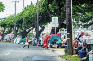 DENNIS ODA / APRIL 22
                                The tents of the homeless and their possessions line the sidewalk along Dillingham Boulevard near Costco.
