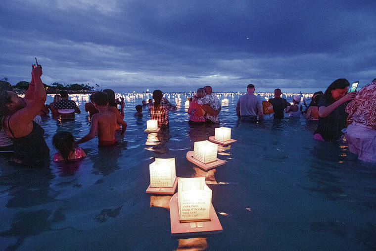 CINDY ELLEN RUSSEL L/ CRUSSELL@STARADVERTISER.COM 
                                People set lanterns afloat at last year’s Shinnyo Lantern Floating Hawai‘i Ceremony at Ala Moana Regional Park. This year’s ceremony was canceled due to the coronavirus pandemic.