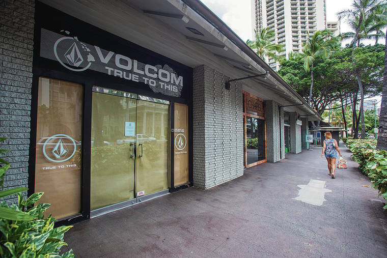 DENNIS ODA / DODA@STARADVERTISER.COM
                                Waikiki still isn’t crowded, a byproduct of a collapsed tourism industry because of the pandemic. Shops were closed Tuesday along Kalakaua Avenue.