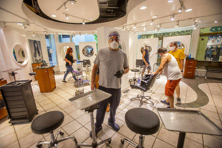 DENNIS ODA / DODA@STARADVERTISER.COM
                                Paul Brown and his staff rearranged his Ward Centre salon to practice social distancing. He had 22 stylists working in the main salon area, but he reduced that to seven.
