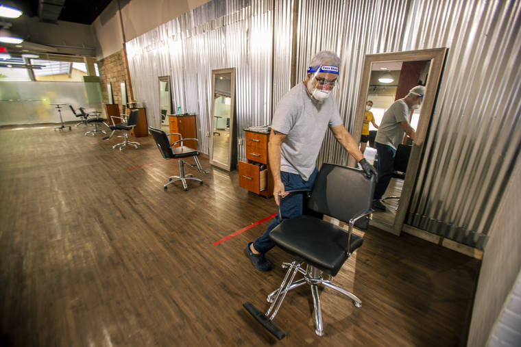 DENNIS ODA / DODA@STARADVERTISER.COM
                                Salon owner and stylist Paul Brown readied a new pop-up location next to his salon. Brown, 72, wanted to ensure the safety of his customers and workers.