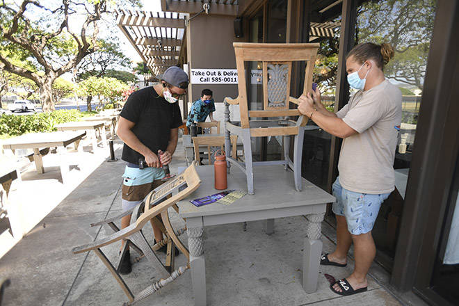 BRUCE ASATO / BASATO@STARADVERTISER.COM
                                Chef Chai Chaowasaree, in back, and workers Cole Freund, left, and Joakim Soderqvisthad make changes Thursday to the Chef Chai restaurant layout to accommodate social-distancing rules as they prepare for the Kapiolani Boulevard restaurant’s reopening on June 5. As Hawaii’s COVID-19 infection rate remains low, more businesses are being allowed to reopen.