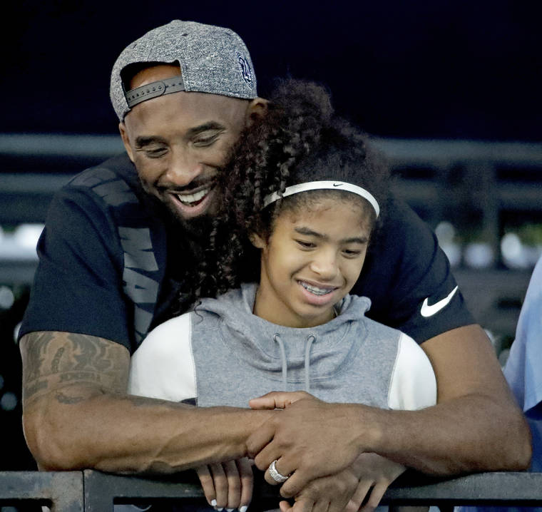 ASSOCIATED PRESS / JULY 26, 2019
                                Former Los Angeles Laker Kobe Bryant and his daughter Gianna watched during the U.S. national championships swimming meet in Irvine, Calif.