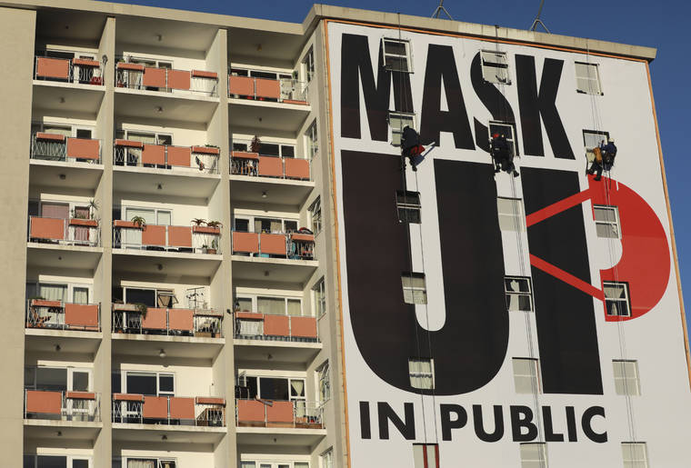 ASSOCIATED RPESS
                                A billboard is installed on an apartment building encouraging people to wear face masks in Cape Town, South Africa.