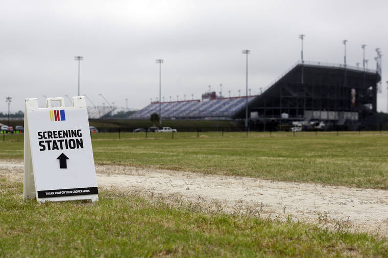 ASSOCIATED PRESS
                                A sign directs people to a screening station outside Darlington Raceway today in Darlington, S.C. NASCAR, which has been idle since March 8 because of the coronavirus pandemic, made its return with the Real Heroes 400 Nascar Cup Series auto race today.