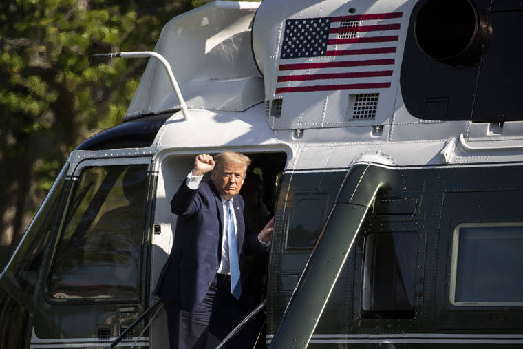 ASSOCIATED PRESS
                                President Donald Trump pumped his fist as he departed the White House on Marine One today.