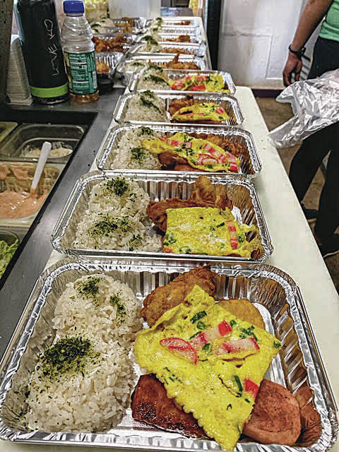 SHOW ALOHA COURTESY PHOTO
                                Above, food is lined up and ready for packing at Blue Ginger, a restaurant on Lanai. Restaurants contract to make 60 meals per day that go to needy seniors.