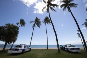 CINDY ELLEN RUSSELL / CRUSSELL@STARADVERTISER.COM
                                Honolulu police kept vigil at Fort DeRussy Beach Park in Waikiki on Wednesday.