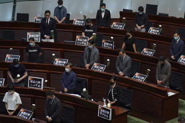 ASSOCIATED PRESS
                                Pan-democratic legislators observe one minute of silence for the 31st anniversary of Tiananmen crackdown before a Legislative Council meeting to debate national anthem bill in Hong Kong, Thursday.
