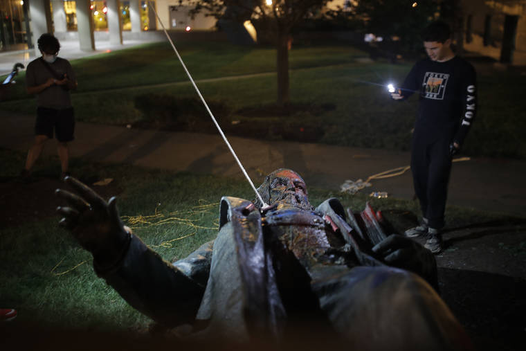 ASSOCIATED PRESS
                                People film the only statue of a Confederate general, Albert Pike, in the nation’s capital after it was toppled by protesters and set on fire in Washington early today.