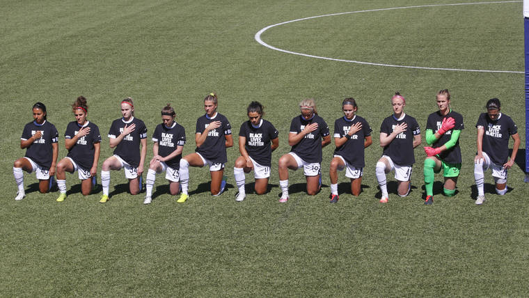 ASSOCIATED PRESS
                                Players for the Portland Thorns kneel during the national anthem before the start of their NWSL Challenge Cup soccer match against the North Carolina Courage at Zions Bank Stadium today.