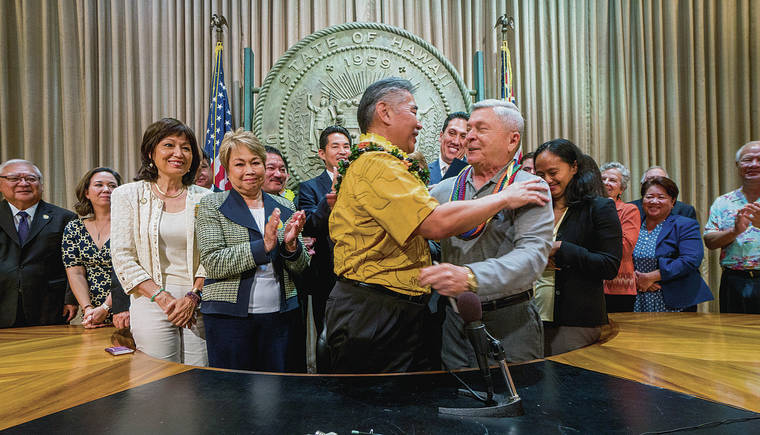 DENNIS ODA / 2018
                                Gov. David Ige hugs cancer-stricken lobbyist John Radcliffe after Ige signed House Bill 2739, the Our Care, Our Choice Act, making Hawaii the seventh jurisdiction to have an end-of-life choice. Radcliffe first filed the right-to-die suit.