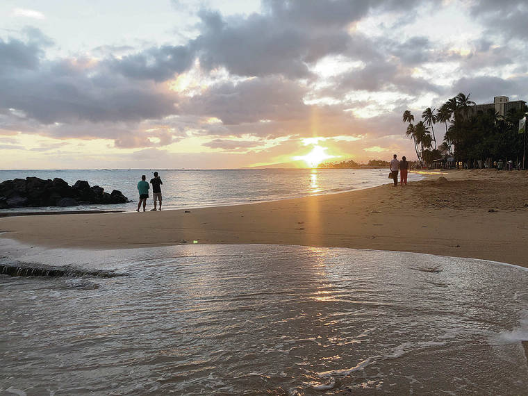 GEORGE F. LEE / GLEE@STARADVERTISER.COM
                                Gov. David Ige has not set an official date to lift the mandatory 14-day quarantine for trans-Pacific travel. Visitors to Waikiki Beach were sparse at sunset earlier this month.