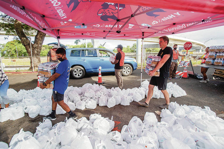 DENNIS ODA / DODA@STARADVERTISER.COM
                                Volunteers unloaded cases of water to give away at the Show Aloha Challenge at Aloha Stadium on Tuesday.