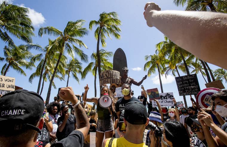 CINDY ELLEN RUSSELL / CRUSSELL@STARADVERTISER.COM
                                Roughly 1,000 protesters marched in unity from Magic Island to the Duke Kahanamoku statue at Kuhio Beach in Waikiki on Friday.