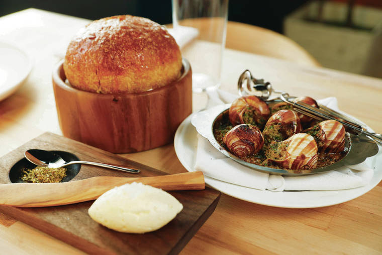 JAMM AQUINO / JAQUINO@STARADVERTISER.COM
                                Escargot in a French vadouvan, or curry, may be added to the prix-fixe experience at Miro Kaimuki. It is served here alongside fresh-baked bread, with butter and a spice blend.