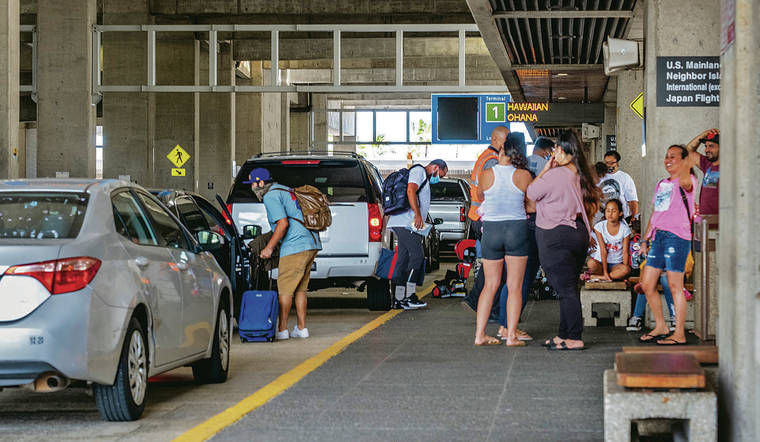 DENNIS ODA / DODA@STARADVERTISER.COM
                                Above, travelers were picked up and dropped off curbside at Terminal 1 of Daniel K. Inouye International Airport on Monday. Today could see an uptick in neighbor island travelers as the 14-day interisland quarantine is lifted.