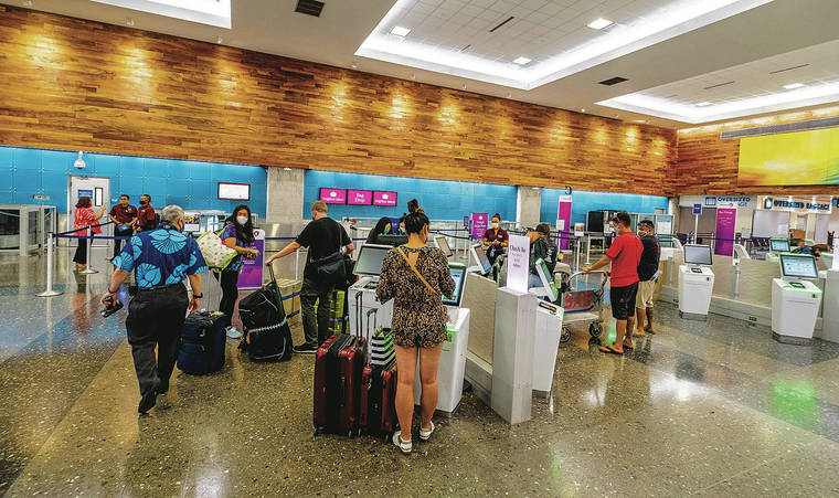 DENNIS ODA / DODA@STARADVERTISER.COM
                                Terminal 1 at Daniel K. Inouye International Airport was relatively busy with travelers Monday. It could become busier today when the 14-day interisland travel quarantine is lifted.