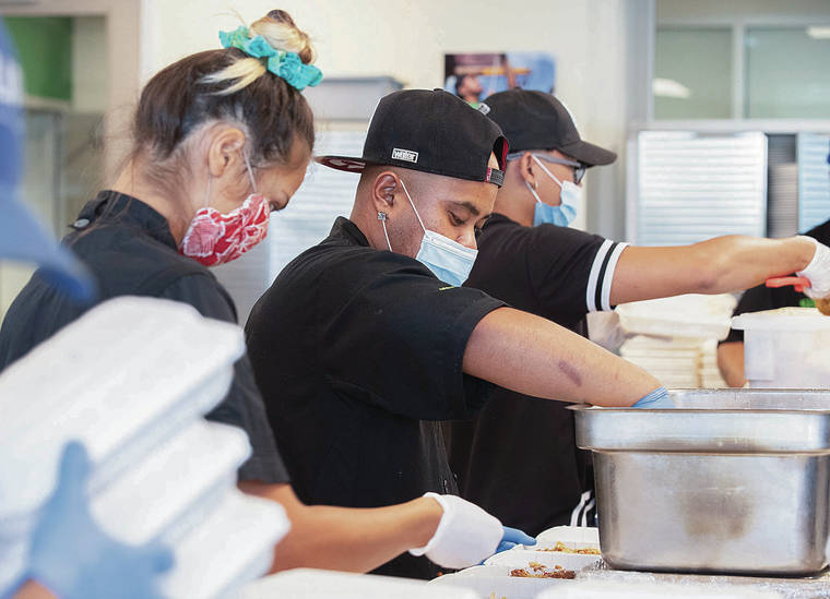 CINDY ELLEN RUSSELL / CRUSSELL@STARADVERTISER.COM
                                Kupu Hawaii’s Data Sananap packed meals with youth participants earlier this month. “It helped me reset my life. If it wasn’t for Kupu, I’d either be dead, on drugs or still selling drugs,” Sananap said.