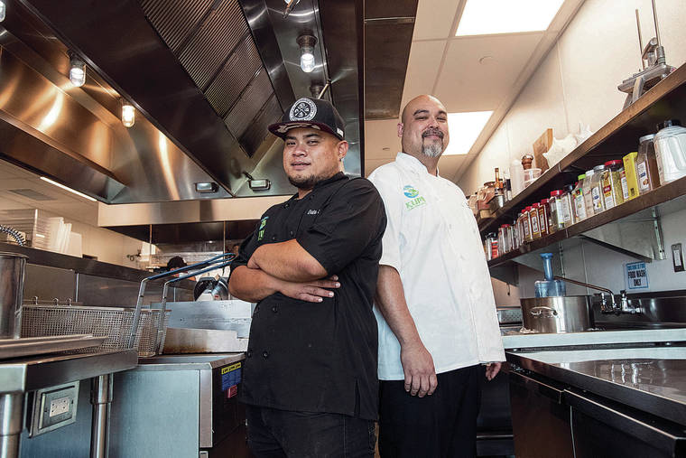 CINDY ELLEN RUSSELL / CRUSSELL@STARADVERTISER.COM
                                Kupu Hawaii’s culinary arts program prepares 1,000 meals a day for food distribution around the island. Pictured in the kitchen is head chef Eddie Mafnas, right, with Kupu Hawaii graduate turned staff Data Sananap.