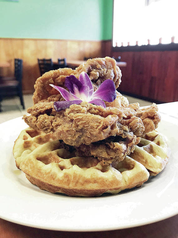 NADINE KAM / SPECIAL TO THE STAR-ADVERTISER
                                Crisp, light, fried chicken sits atop a waffle at Guieb Cafe.