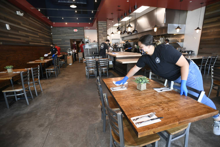 BRUCE ASATO / BASATO@STARADVERTISER.COM
                                Cassidy Essex cleans a seating area at Scratch Kitchen in the South Shore Market today.