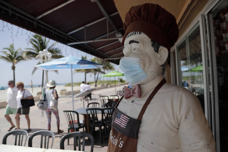 ASSOCIATED PRESS
                                A statue of a chef at Florio’s of Little Italy restaurant wears a protective face mask on the Hollywood Beach Broadwalk during the new coronavirus pandemic Thursday, in Hollywood, Fla. In hard-hit South Florida, beaches from Palm Beach to Key West will be shut down for the Fourth of July holiday weekend.